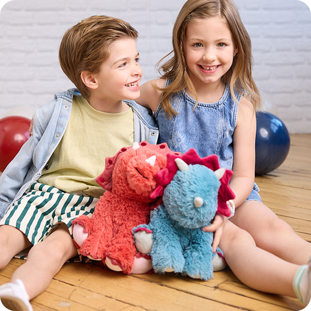 Image 102: kids playing with triceratops stuffed animal warmies