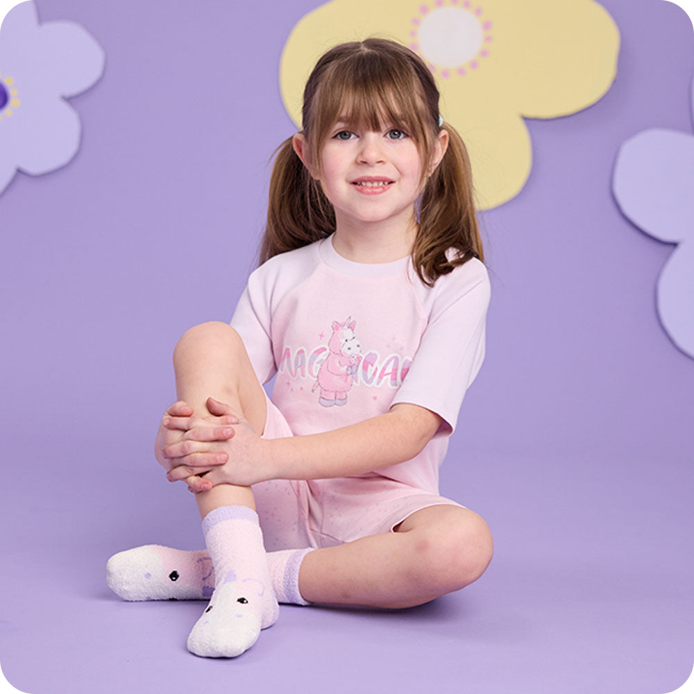 Image 92: girl wearing warmies unicorn pajamas